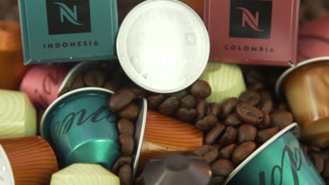 tilting-up-view-of-coffee-beans-and-Nespresso-capsules-and-Nespresso-coffee-boxes