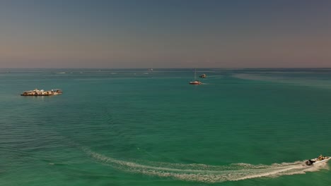 Aerial-shot-flying-towards-a-catamaran-sailing-to-the-left