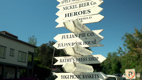 Wooden-directional-signs-showing-the-way-to-businesses-in-Julian,-California,-located-in-San-Diego-County