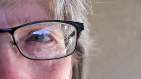 Close-up-on-the-eye-of-an-aging-old-woman-getting-an-exam-at-the-optometrist-for-prescription-lens-glasses