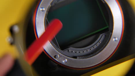 Close-up-shot-of-hand-Cleaning-Lens-From-Dust-With-Brush-looking-through-magnifier