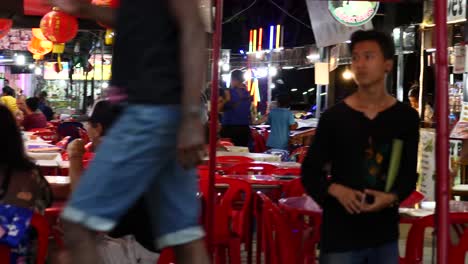 Night-market-food-court-and-tourists-with-waiters-serving-and-ready-to-serve