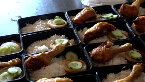 A-row-of-Nasi-Lemak-with-Roasted-Chicken-in-lunch-boxes-container-for-selling-purpose-in-London-street-market