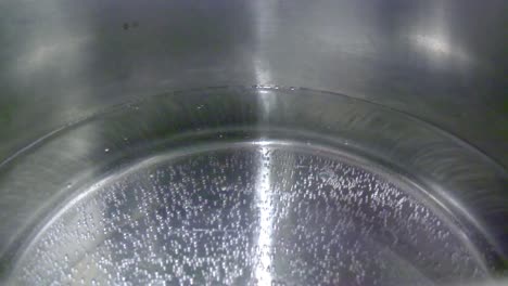 Closeup-of-boiling-water-in-silver-pot