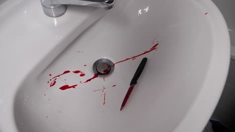 Throwing-homicide-murder-knife-weapon-in-sink-in-slow-motion
