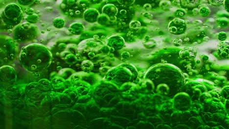 Makroaufnahme-Einer-Reihe-Grüner-Blasen-Im-Wasser,-Die-Sich-Ständig-Bewegen