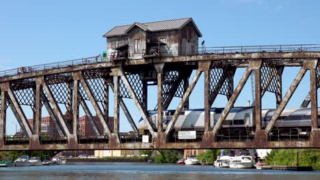 locomotive-passes-backward-on-old-vertical-lift-bridge-over-river-4k