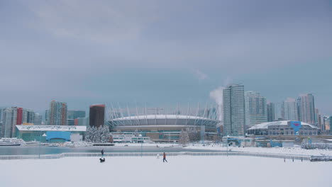 Snowy-Downtown-Vancouver-Skyline-with-Dog-and-Man-Playing