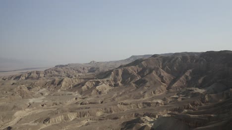 Aerial-wide-shot-of-the-Dead-Sea-desert-mountains-,-clear-sky-day,-drone-shot