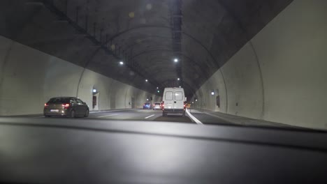 Footage-from-E94-national-highway-of-Greece,-car-drives-through-an-underground-tunnel
