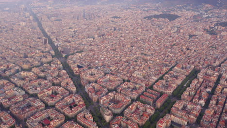 Aerial-view-of-square-blocks-in-new-quarter-of-Barcelona-at-sunrise,-Diagonal-Avenue,-Spain