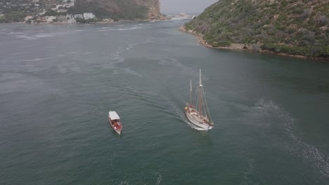 Aerial:-Sailing-ship-and-tour-boat-in-Knysna-Harbour-lagoon