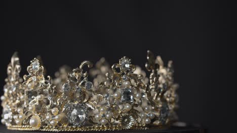 Crown-of-diamonds,-pearls-and-silver-on-a-turntable-stand-display-spins-in-glorious-beauty---for-queen,-bride-or-pageant-winner