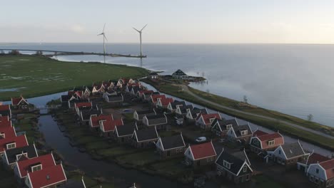 Aerial-of-a-Small-Dutch-Holiday-Park-with-the-Ocean-and-Two-Windmills-in-the-Background
