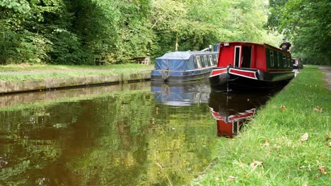 British-staycation-scenic-canal-boat-touring-tourism-holiday-vacation-waterway-idyllic-lifestyle-passing-camera