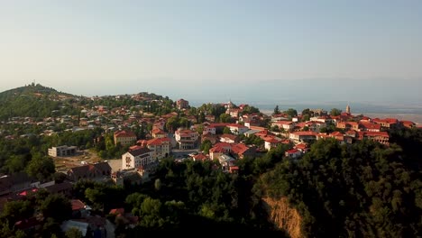 Sunset-In-Sighnaghi-Georgia-With-the-landscape-Of-Great-Wall-Of-Fortress-And-Orange-Color-Building-Roofs-And-Brick-Houses-in-Mild-Blue-Sky-Golden-Time