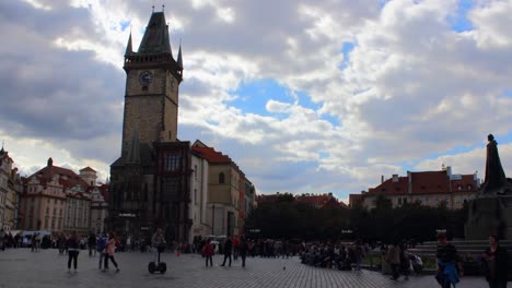 Old-town-city-hall-clock-tower-from-square-in-Prague,-Stare-Mesto,-Czech-Republic-in-hyperlapse-from-from-right-to-left