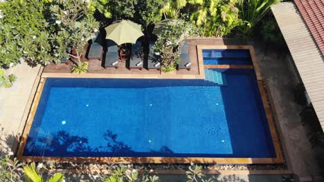 High-Tracking-Drone-Shot-of-a-Tropical-Hotel-Grounds-and-Swimming-Pool