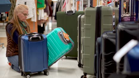 Woman-looking-at-luggage-in-a-hypermarket