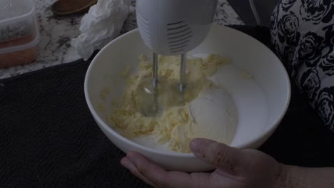 Electric-Mixer-Being-Used-In-Bowl-To-Whisk-Butter-And-Sugar