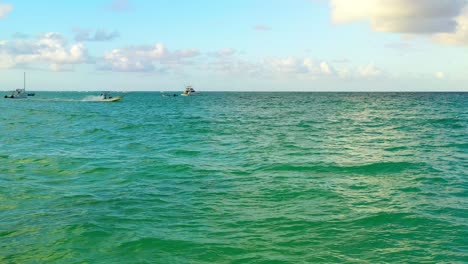 Kleines-Motorboot,-Das-An-Einem-Sonnigen-Tag-Auf-Grünem-Meerwasser-Fährt,-Punta-Cana,-Dominikanische-Republik,-über-Dem-Luftanflug