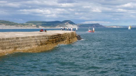 A-fishing-boat-returns-to-Lyme-regis-harbour-on-the-coast-of-dorset