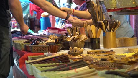 Tourist-trying-wooden-massager-on-his-hand-in-Chiang-Mai-local-market