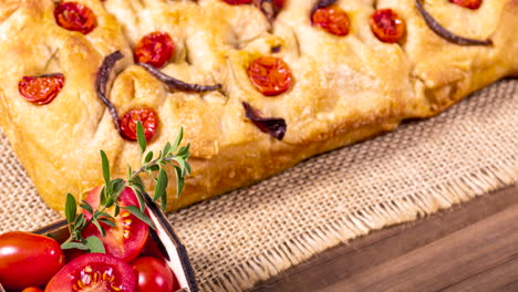 Traditional-Italian-Focaccia-with-cherry-tomatoes,-black-olives-and-rosemary