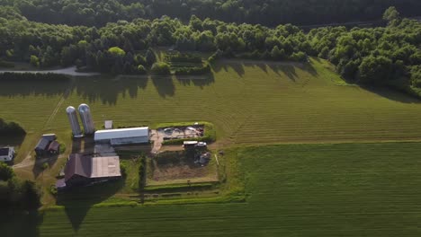 Silos-And-Barnhouse-On-The-Lush-Farmland-In-Leelanau-County,-Michigan-On-A-Sunny-Day---aerial