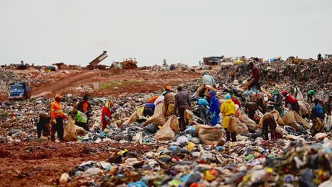 A-large-group-of-impoverished-people-search-and-sift-through-a-garbage-dump-for-supplies-to-live
