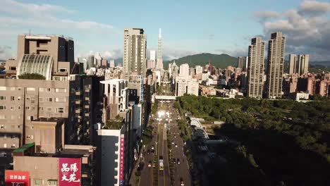 Taiwan,-Taipei-City,-Aerial-View-on-Xinyi-Road,-Daan-Forest-Park-and-Taipei-Tower-Landmark-on-Golden-Hour