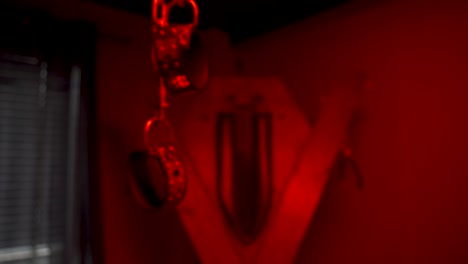 Bondage-and-kinky-handcuffs-in-a-red-room