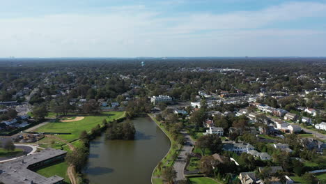 A-high-angle-view-over-a-long-green-pond-in-a-suburban-neighborhood-on-Long-Island,-NY