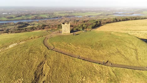 Runners-on-scenic-Rivington-tower-Lancashire-reservoir-countryside-aerial-view-orbit-left