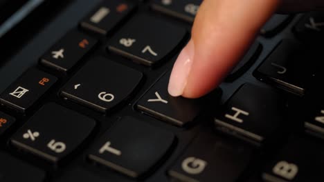 Pushing-Y-button-on-the-black-keyboard