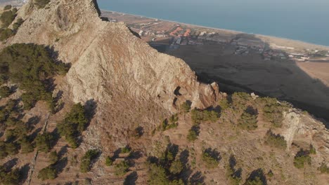 Aerial-close-shot-tilt-up-Volcanic-summit-scene,-Porto-Santo-island