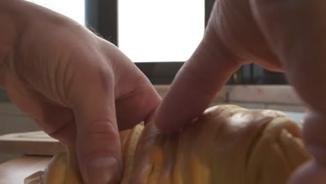Placing-Delicious-Croissant-Bread-With-Ham-Filling-On-A-Plate---close-up,-slow-motion