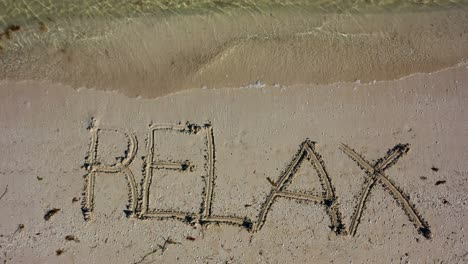 Static-shot-of-RELAX-written-in-the-sand