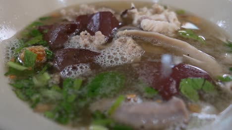 Close-up-Footage-of-Pig-Blood-Pudding-and-Pork-Insides-Soup,-Thai-Popular-Breakfast-Selling-in-Both-Restaurant-and-Street-Market