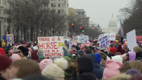 Large-group-of-protesters-with-women's-rights-signs-gathered-on-the-streets-of-Washington-DC-by-the-Capitol-participating-in-the-Women's-March