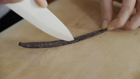 Cutting-bourbon-vanilla-stick-in-half-with-knife