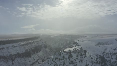 Wide-panning-drone-shot-of-snowy-canyon