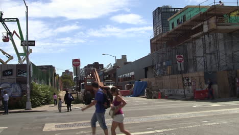 Brooklyn-Gentrification,-Locals-and-Tourists-Walk-By-Construction-Development-on-Sunny-Day