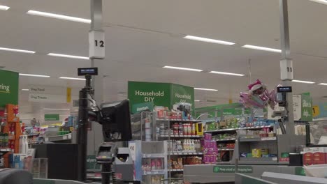 Slow-motion-interior-empty-UK-supermarket-dolly-right-passing-closed-store-aisles