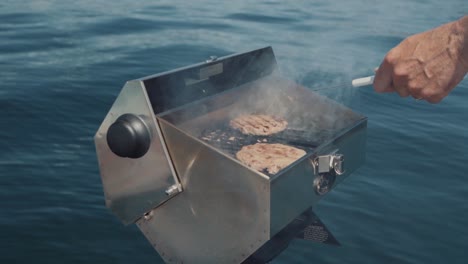 Man-Grilling-on-a-Boat-While-Enjoying-a-Day-on-the-Water