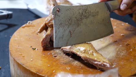 Close-up-Footage-of-Street-Food-Vendor-Chopping-Chinese-stewed-duck-On-Wooden-Cutting-Board