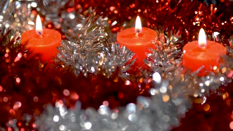 Lighting-and-extinguishing-of-candles-with-beautiful-Christmas-decorations-in-silver-and-red,-copyspace-at-the-bottom-of-the-video