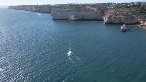 Aerial:-beautiful-sailing-yacht-cruising-along-Mediterranean-Sea-coast,-arc-shot