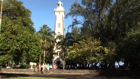 Tourists-visiting-The-Point-Venus-and-its-lighthouse-in-Papeete,-Tahiti