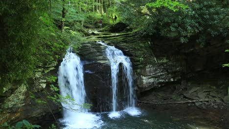 A-young-man-fishes-above-Seneca-Falls,-a-large-waterfall-located-along-Seneca-Creek,-within-the-Spruce-Knob-Seneca-Rocks-National-Recreation-Area-in-West-Virginia